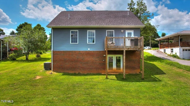 back of house featuring central AC, a lawn, a deck, and french doors