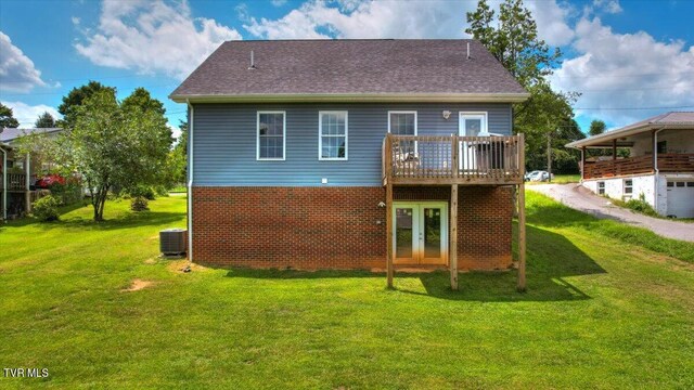 back of house featuring a yard, central AC, and a deck