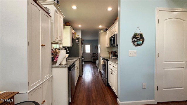 kitchen featuring white cabinetry, stainless steel appliances, dark hardwood / wood-style floors, and stone counters