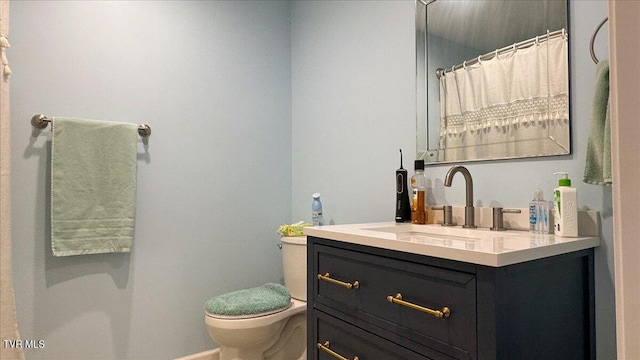 bathroom with toilet and vanity