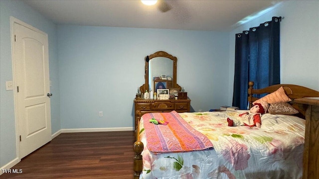 bedroom with dark hardwood / wood-style flooring