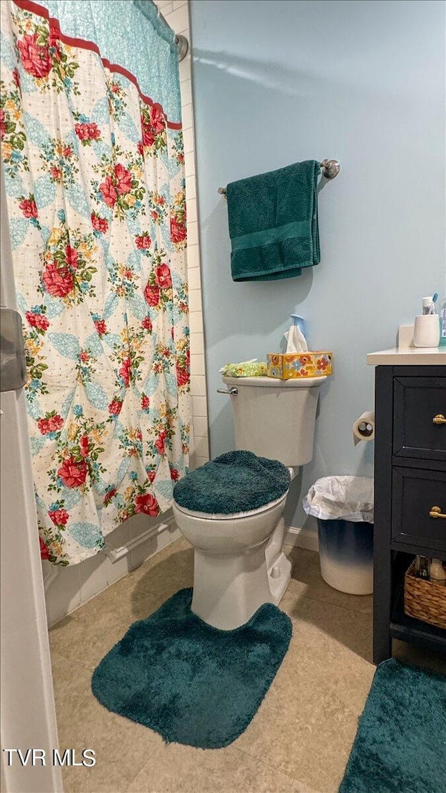 bathroom with vanity, curtained shower, and toilet