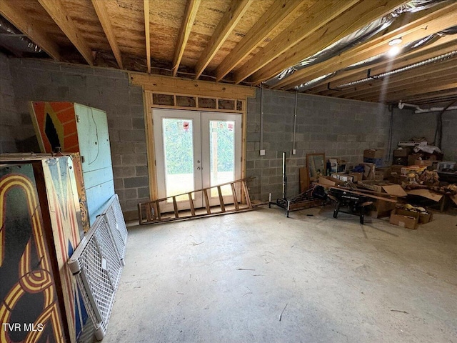 misc room with french doors and concrete floors