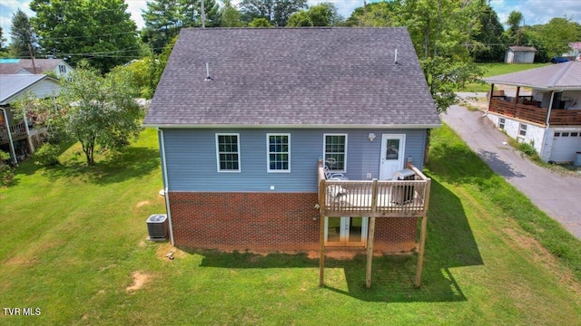 back of house with central AC unit, a yard, and a wooden deck