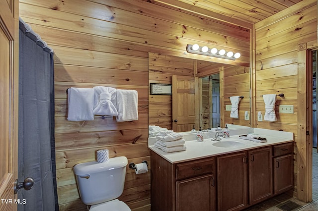 bathroom with vanity, wood walls, tile patterned flooring, toilet, and wood ceiling