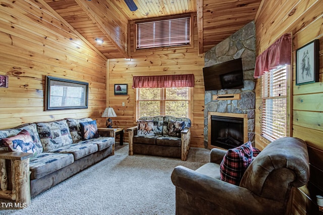 carpeted living room with a fireplace, ceiling fan, wood walls, and wood ceiling