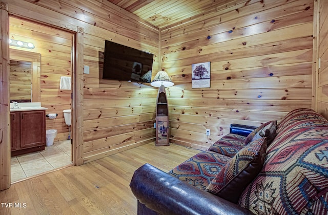 interior space with wood walls, light hardwood / wood-style floors, and wooden ceiling