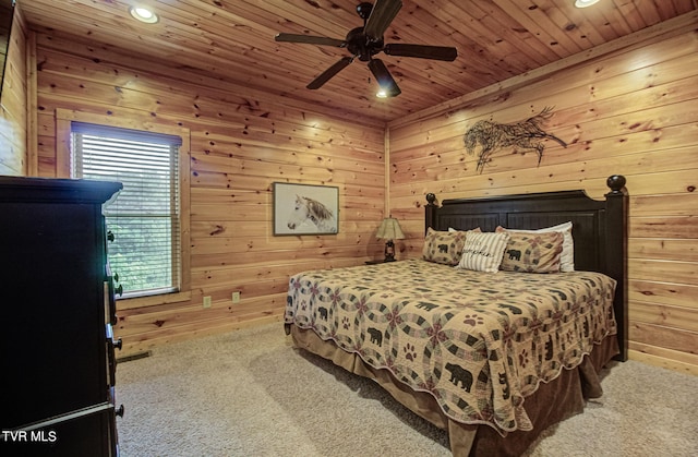 bedroom with carpet, wooden ceiling, ceiling fan, and wooden walls