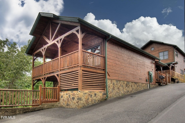 view of home's exterior featuring a wooden deck