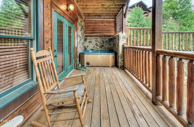 wooden terrace with a hot tub