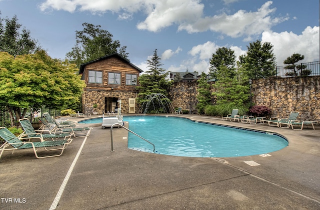 view of pool featuring a patio area and a fireplace