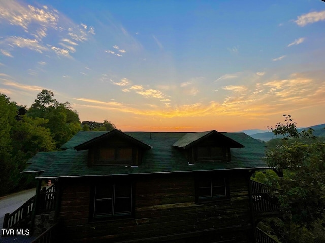 view of back house at dusk