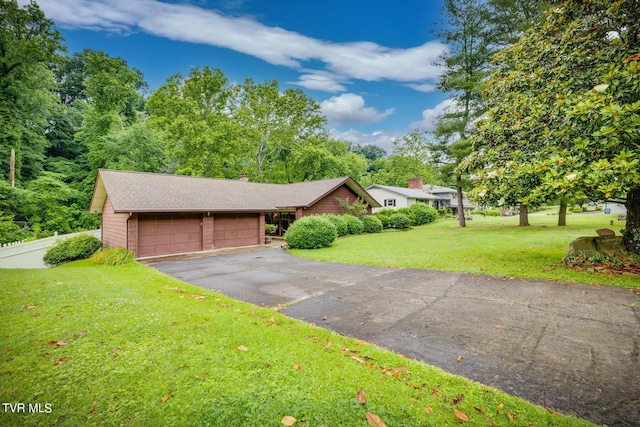 ranch-style home with a front yard and a garage