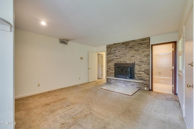 unfurnished living room with light colored carpet and a textured ceiling