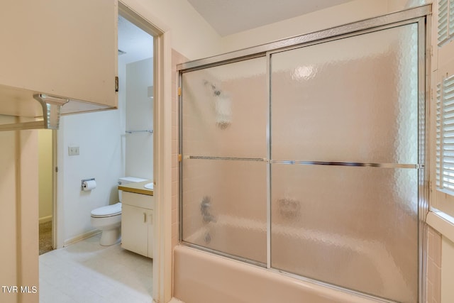 full bathroom featuring combined bath / shower with glass door, toilet, and vanity