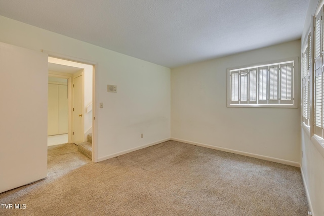 unfurnished room with light carpet