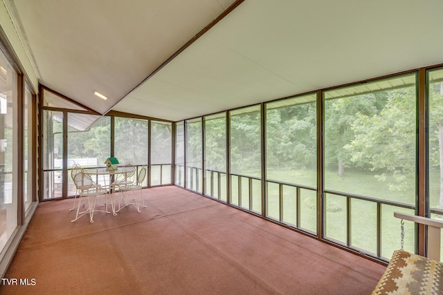 unfurnished sunroom featuring vaulted ceiling