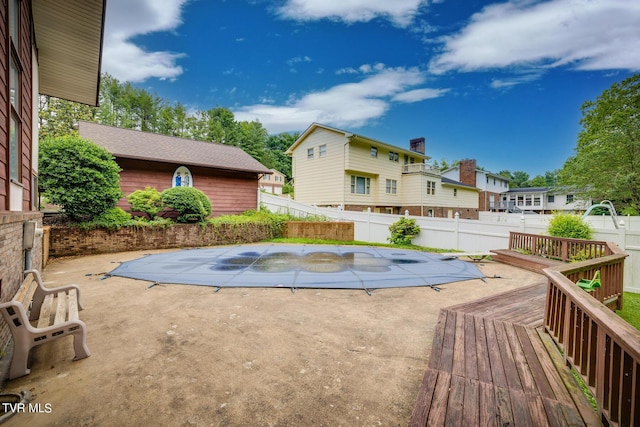 view of swimming pool featuring a patio area and a wooden deck