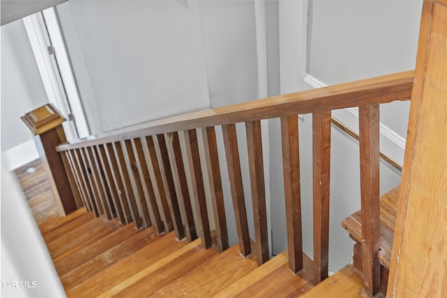 stairs featuring hardwood / wood-style flooring