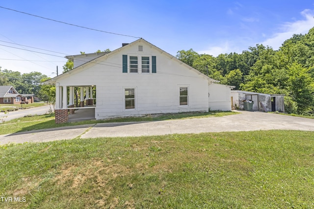 view of side of home featuring a lawn