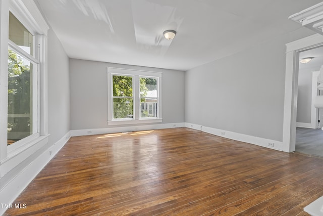 unfurnished room with dark wood-type flooring