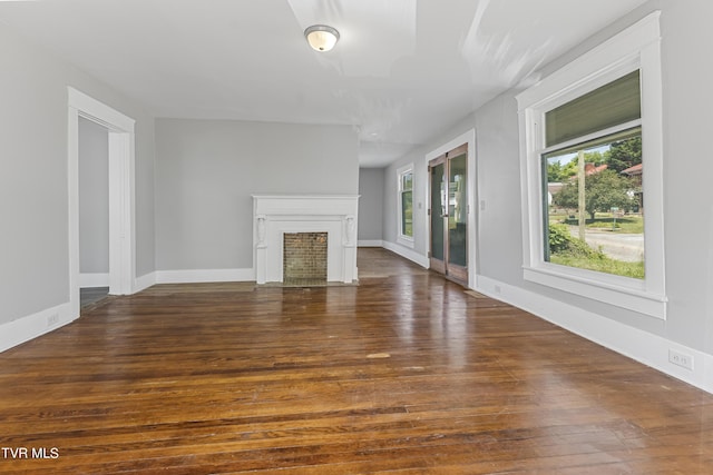 unfurnished living room with dark hardwood / wood-style floors