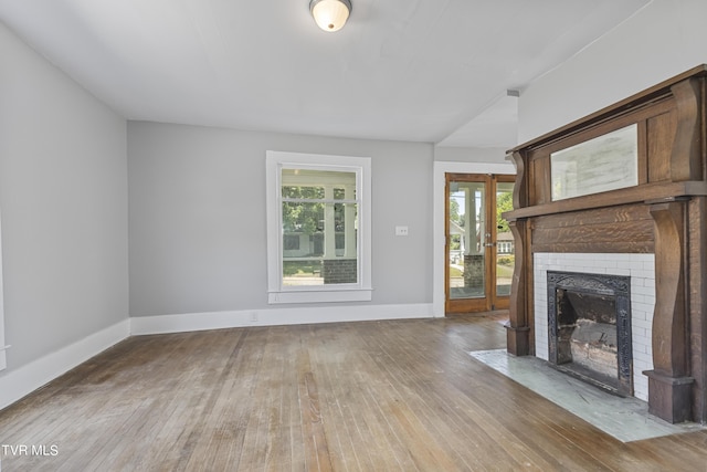 unfurnished living room featuring hardwood / wood-style flooring and a fireplace