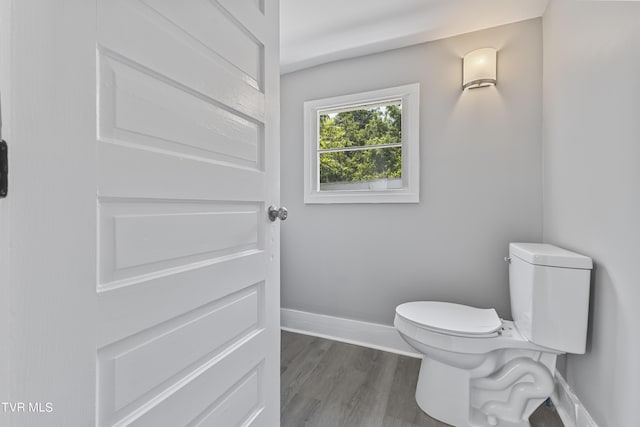 bathroom with toilet and hardwood / wood-style floors