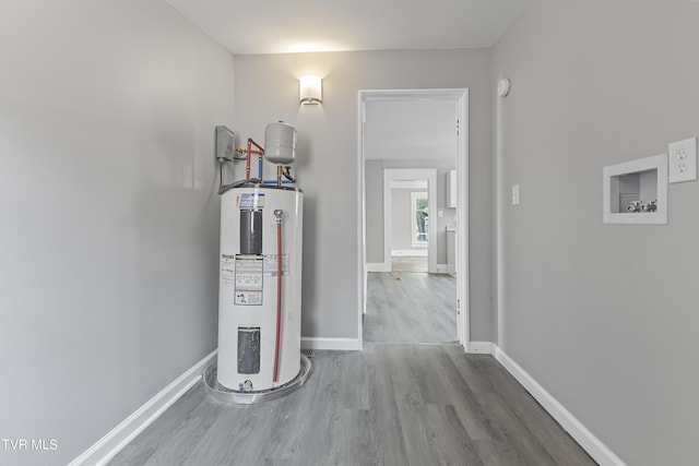 hall with electric water heater and hardwood / wood-style floors