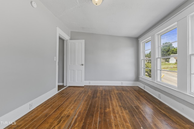 spare room featuring dark hardwood / wood-style flooring