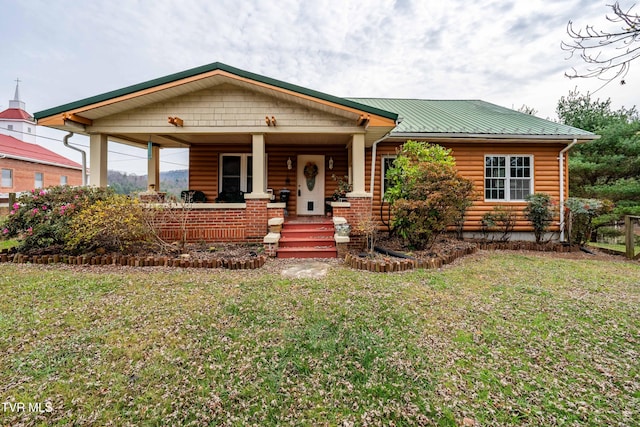 view of front of home featuring covered porch and a front yard