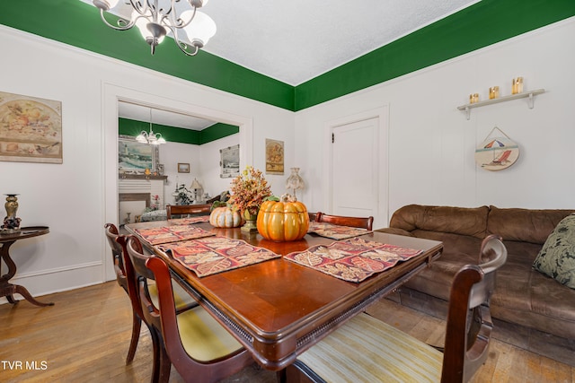 dining space with a chandelier and hardwood / wood-style flooring