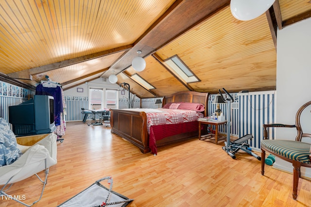 bedroom with vaulted ceiling with skylight, light hardwood / wood-style floors, and wood ceiling