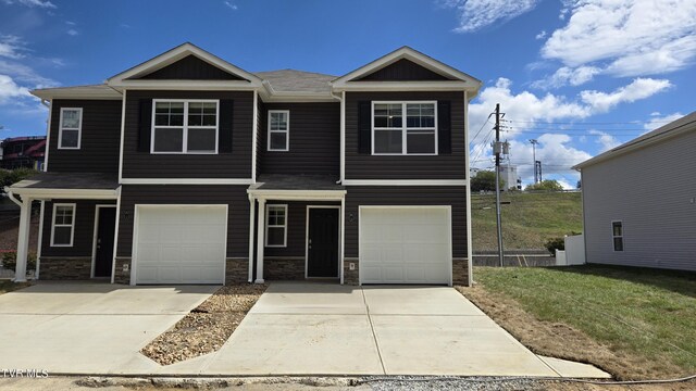 110 Raceday Center Dr Unit A-2, Bristol, TN 37620 - view of front facade with stone siding, an attached garage, concrete driveway, and a front yard