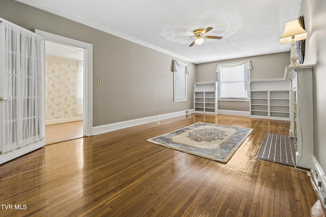 unfurnished bedroom featuring hardwood / wood-style floors, ceiling fan, and a textured ceiling