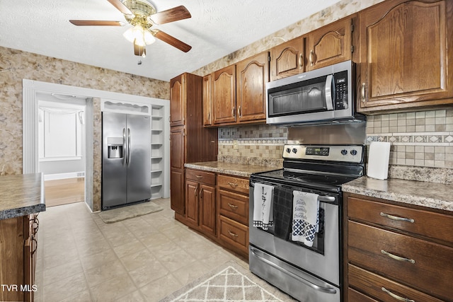 kitchen with decorative backsplash, a textured ceiling, and stainless steel appliances