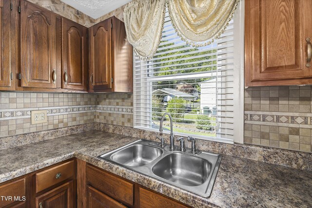 kitchen with sink and tasteful backsplash