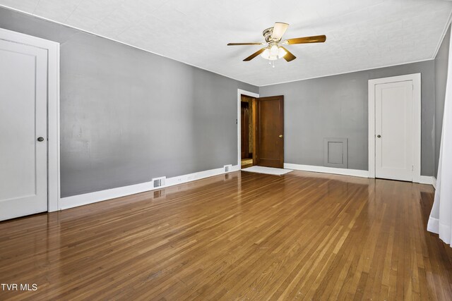 spare room with hardwood / wood-style floors and ceiling fan