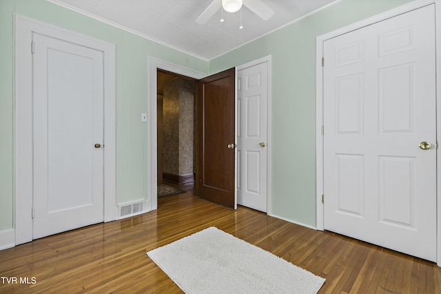 bedroom with ceiling fan, wood-type flooring, and crown molding