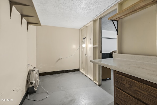 laundry room with a textured ceiling