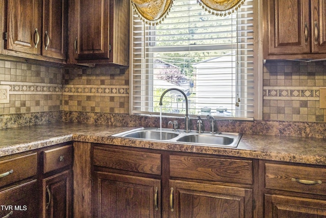 kitchen featuring dark brown cabinets and sink