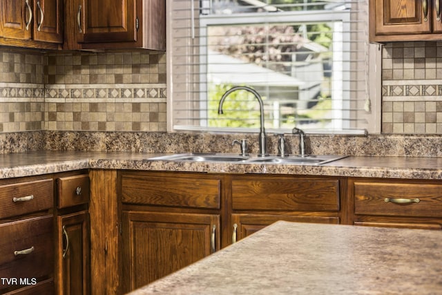 kitchen featuring tasteful backsplash and sink