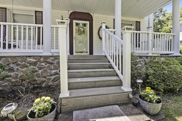 doorway to property featuring covered porch