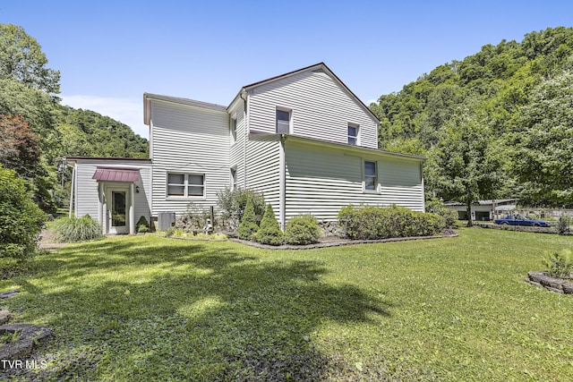 rear view of property featuring a yard