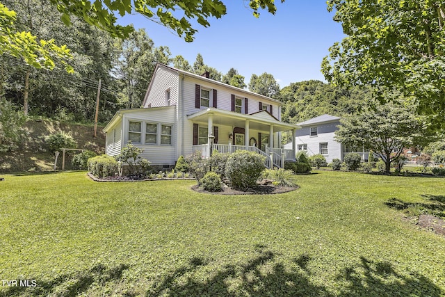 view of front facade with a front yard and a porch