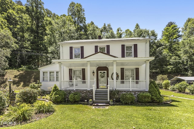 view of front facade with a front lawn and covered porch