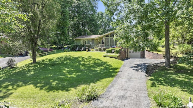 view of front facade with a garage and a front lawn