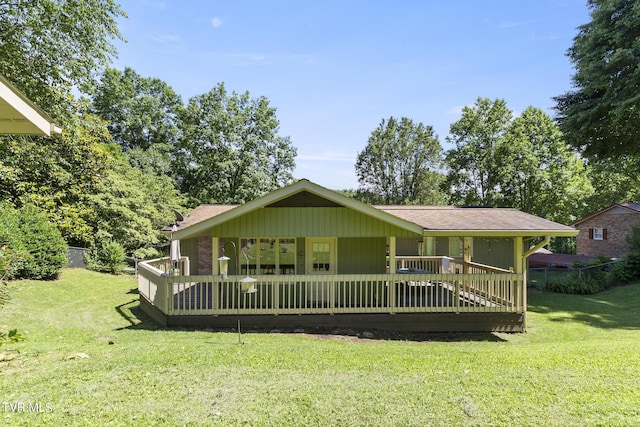 view of front of property with a deck and a front lawn