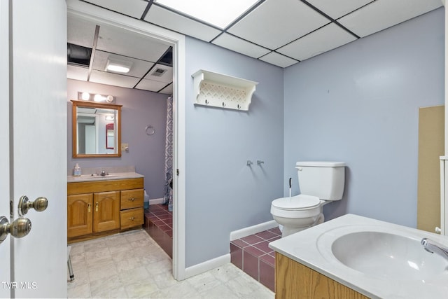 bathroom featuring vanity, a paneled ceiling, and toilet