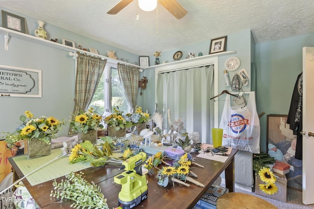 office area featuring ceiling fan and a textured ceiling